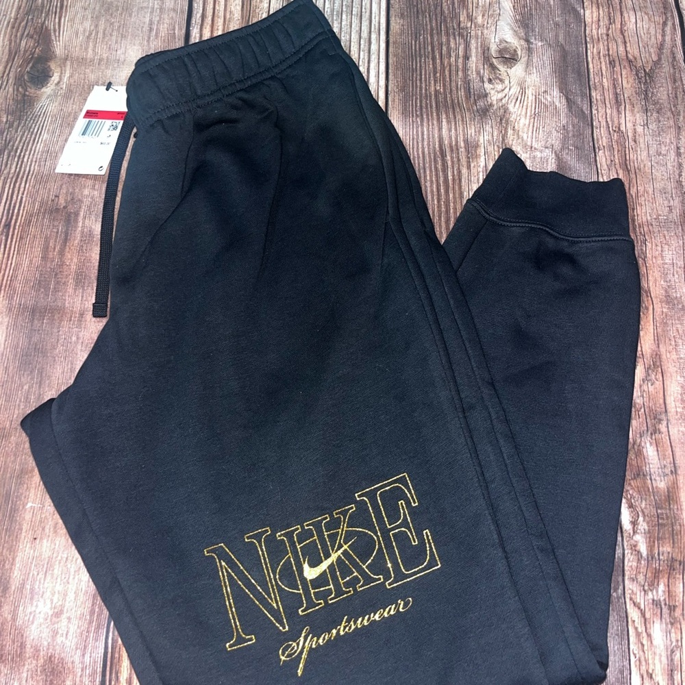 Nike woman’s Black Joggers with Gold Logo size L